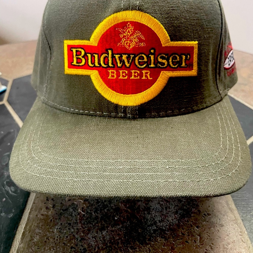 Budweiser Green and Red Hat with strap and buckle design. NEW, NEVER WORN.